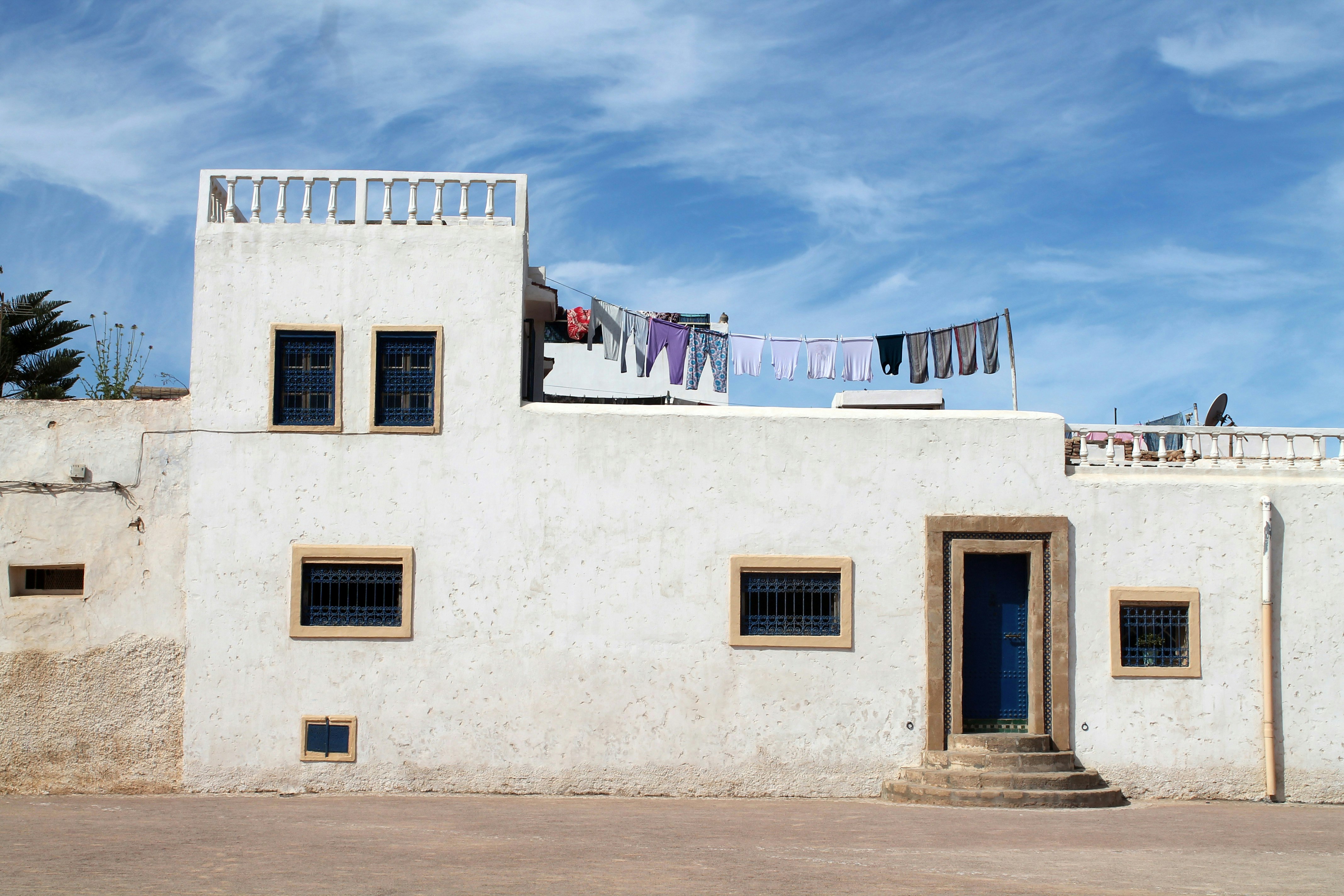 white and grey concrete house under blue sky